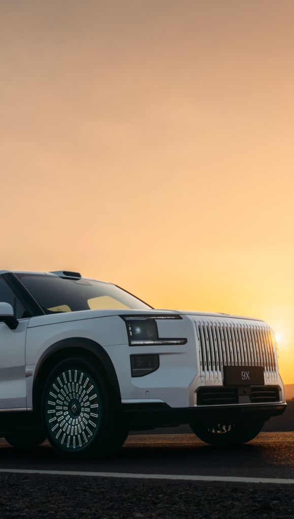White Zeekr 9X SUV front three-quarter view at sunset on a desert road